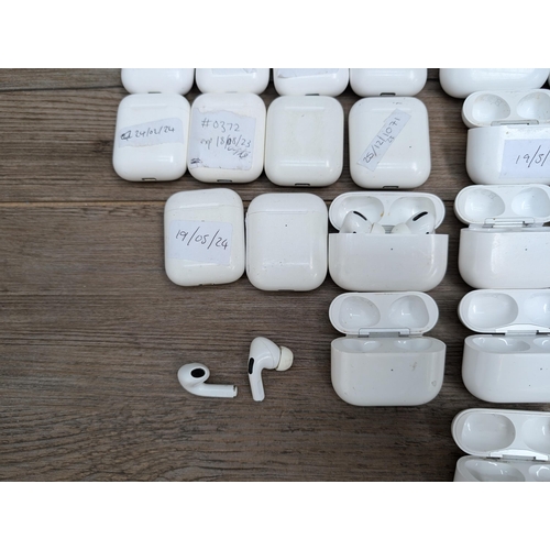 683 - A collection of Apple AirPod and AirPod style charging cases some with contents