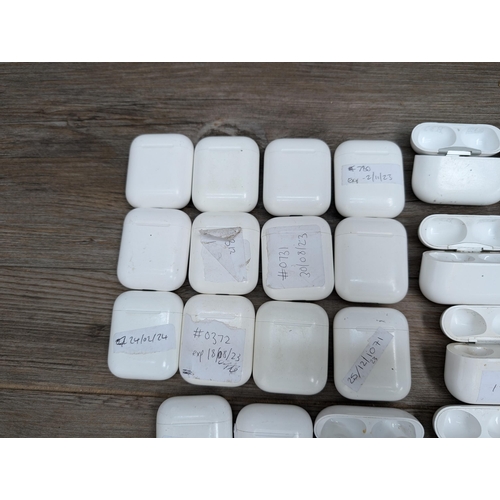 683 - A collection of Apple AirPod and AirPod style charging cases some with contents