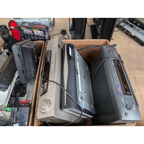 694 - A large collection of AV items to include portable DVD players, Samsung and Panasonic VCRs, Panasoni... 