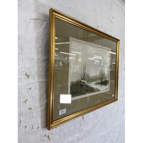 268 - A late 20th century gilt framed Paul Mann watercolour of a lakeside scene - approx. 47cm high x 60cm... 