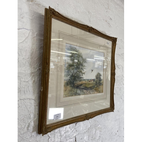 269 - A 20th century gilt framed watercolour of a farm scene signed lower right - approx. 45cm high x 52cm... 