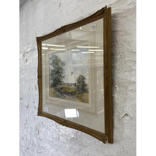 269 - A 20th century gilt framed watercolour of a farm scene signed lower right - approx. 45cm high x 52cm... 