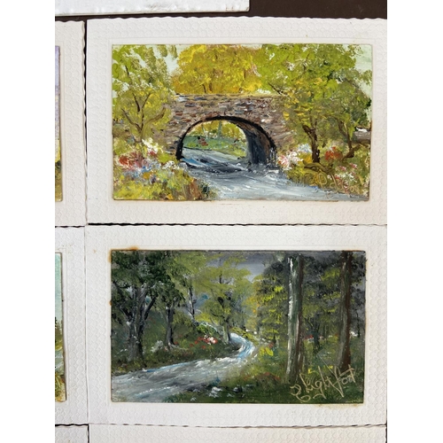 281 - A photograph album containing a collection of vintage acrylic on board paintings of landscape scenes... 