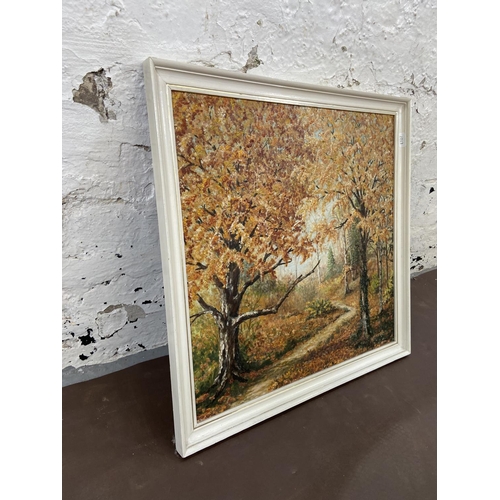 284 - A mid 20th century framed acrylic on board of a woodland scene titled 'Autumn Sunlight' signed lower... 