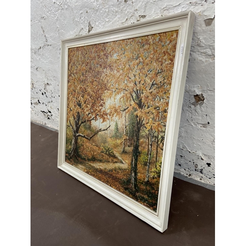 284 - A mid 20th century framed acrylic on board of a woodland scene titled 'Autumn Sunlight' signed lower... 