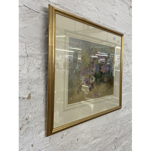 291 - A modern gilt framed watercolour of a still life floral scene signed lower right - approx. 65cm high... 