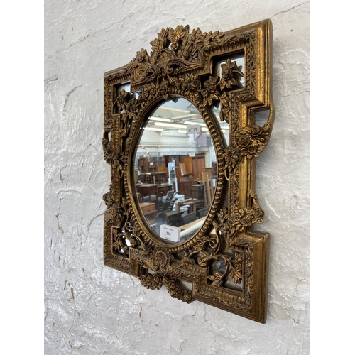 296 - A Rococo style gilt framed wall mirror - approx. 42cm high x 33cm wide