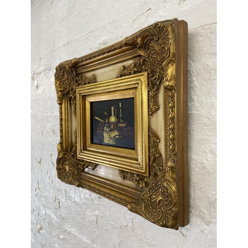 299 - A vintage gilt framed oil on board of a still life scene signed lower right - approx. 38cm high x 41... 