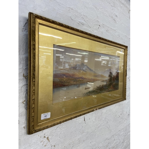 300 - An early 20th century gilt framed watercolour of a lakeside scene - approx. 42cm high x 73cm wide