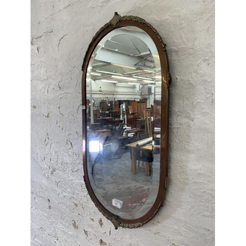 317 - An Art Deco copper and brass framed bevelled edge wall mirror - approx. 72cm high x 36cm wide