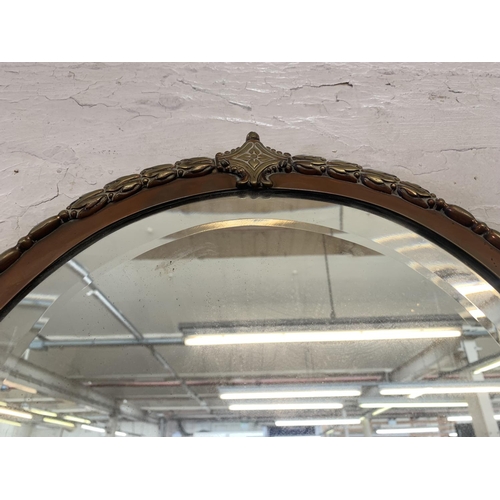 317 - An Art Deco copper and brass framed bevelled edge wall mirror - approx. 72cm high x 36cm wide