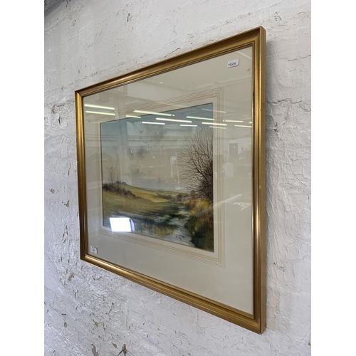 321 - A late 20th century gilt framed Impressionist style watercolour of a landscape signed lower left - a... 