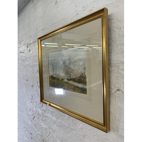 322 - A late 20th century gilt framed Impressionist style watercolour of a landscape signed lower left - a... 