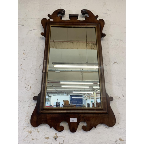 329 - A Georgian mahogany fretwork and parcel gilt wall mirror - approx. 93cm high x 49cm wide