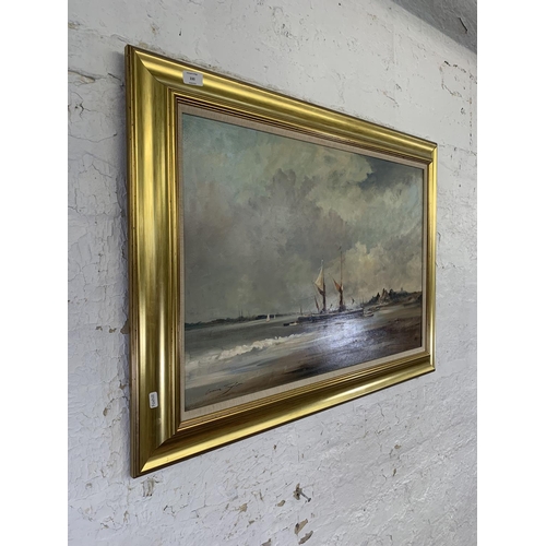 330 - A late 20th century gilt framed Ivan Taylor (b.1946) oil on board of a harbour scene - approx. 69cm ... 