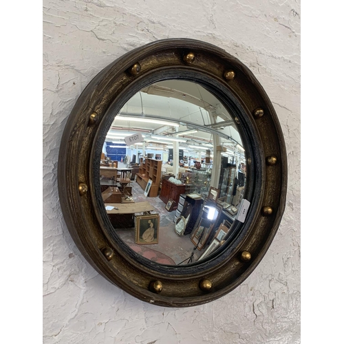 334 - Two wall mirrors, one early 20th century oak framed bevelled edge oval and one Regency style convex ... 