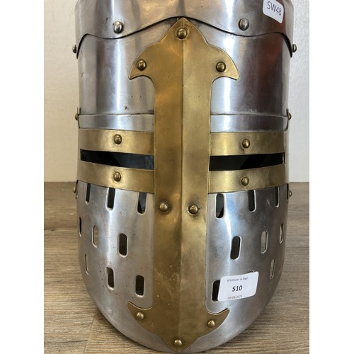 510 - A reproduction Medieval Templar Knight Crusader style brass and steel helmet - approx. 28cm high