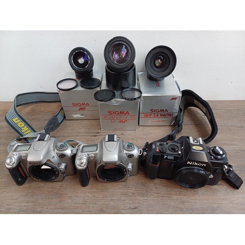 634 - Three Nikon 35mm SLR camera bodies and three boxed Sigma lenses for Nikon, one F-301 and two F55 bod... 