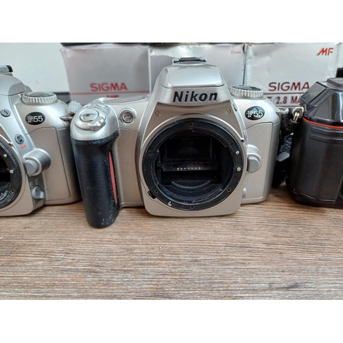 634 - Three Nikon 35mm SLR camera bodies and three boxed Sigma lenses for Nikon, one F-301 and two F55 bod... 