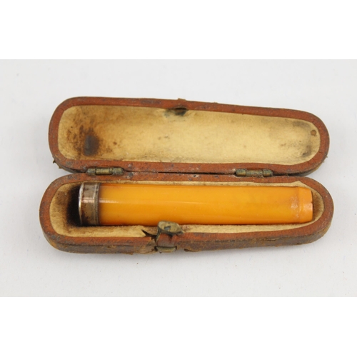 2191 - Three hallmarked sterling silver items, one vesta case, one toothpick and one cased amber cheroot ho... 