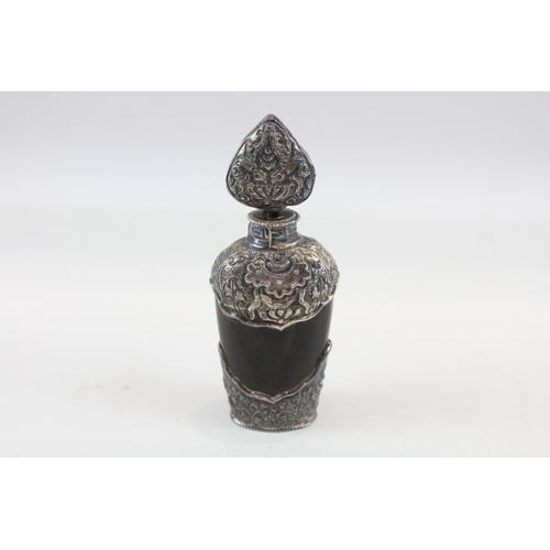 2200 - An antique carved horn scent bottle with .950 silver detailing