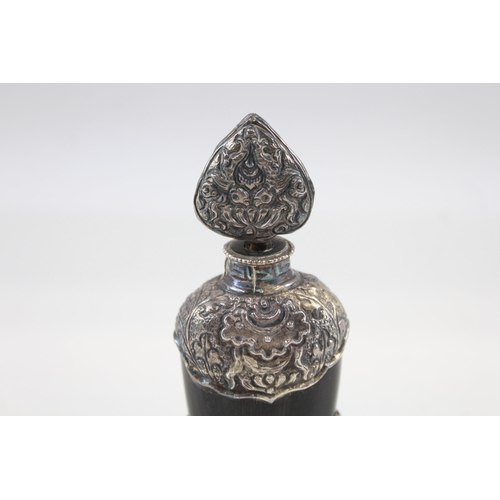 2200 - An antique carved horn scent bottle with .950 silver detailing