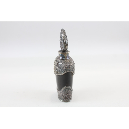 2200 - An antique carved horn scent bottle with .950 silver detailing