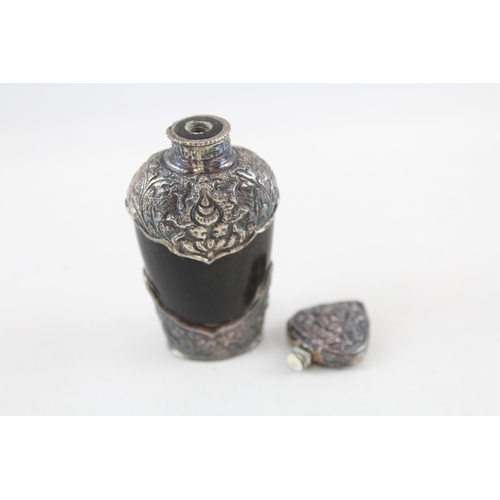 2200 - An antique carved horn scent bottle with .950 silver detailing