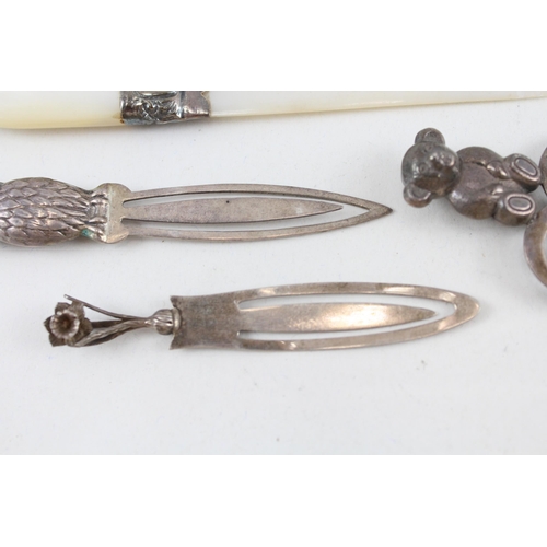 2203 - Four hallmarked sterling silver items, three bookmarks and one mother of pearl letter opener - appro... 