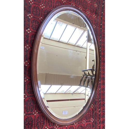 8 - An Edwardian mahogany framed bevelled edge oval wall mirror - approx. 90cm high x 60cm wide