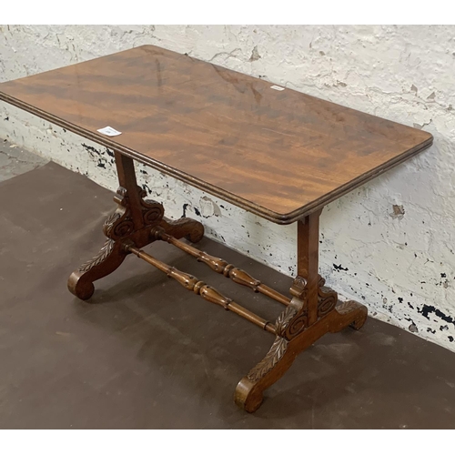 105 - A 19th century style mahogany coffee table with carved supports and lower stretcher - approx. 42cm h... 