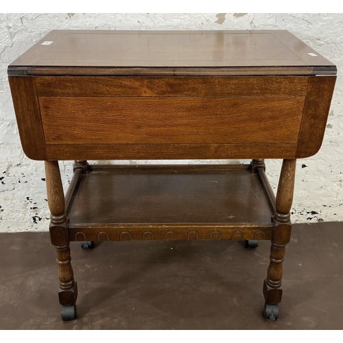 160 - A mid 20th century oak drop leaf two tier tea trolley