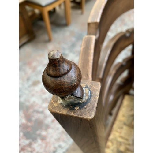 161 - An oak circular extending table on carved baluster support and four chairs - approx. 78cm high x 110... 