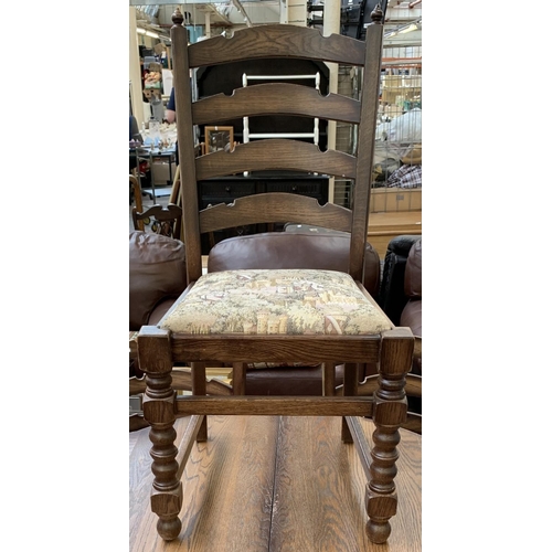 161 - An oak circular extending table on carved baluster support and four chairs - approx. 78cm high x 110... 