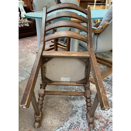 161 - An oak circular extending table on carved baluster support and four chairs - approx. 78cm high x 110... 