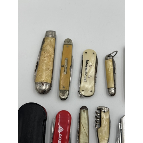 2228 - A collection of pocket knives to include Swiss army, hallmarked Sheffield silver and mother of pearl... 