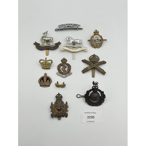 2230 - Ten military cap badges and shoulder titles