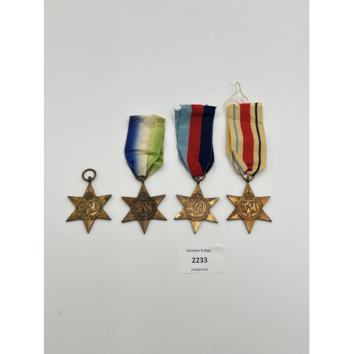 2233 - Four WWII medals, The Atlantic Star, The 1939-1945 Star, The Burma Star and The Pacific Star