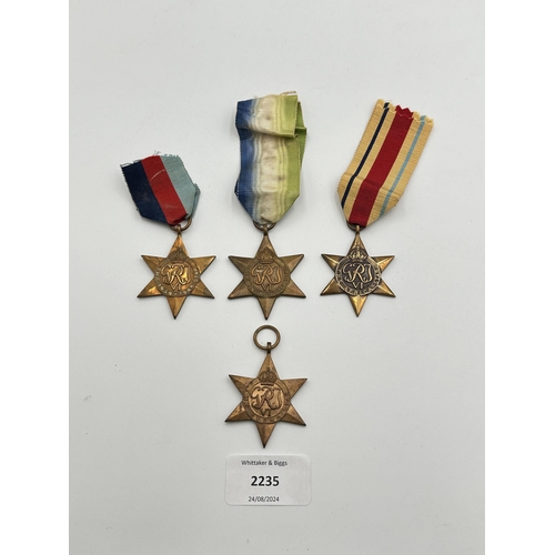 2235 - Four WWII medals, The Atlantic Star, The 1939-1945 Star, The Burma Star and The Pacific Star