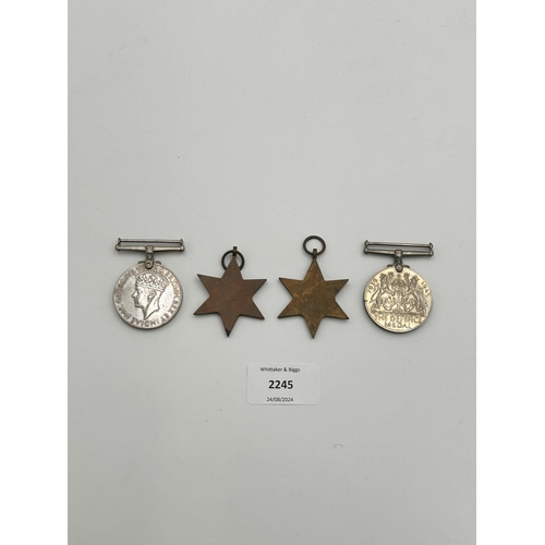 2245 - Four WWII medals, War, The Defence, The Italy Star and the 1939-1945 Star