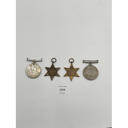 2254 - Four WWII medals, War, The Defence, The Italy Star and the 1939-1945 Star