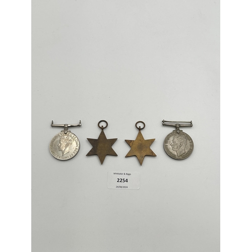 2254 - Four WWII medals, War, The Defence, The Italy Star and the 1939-1945 Star