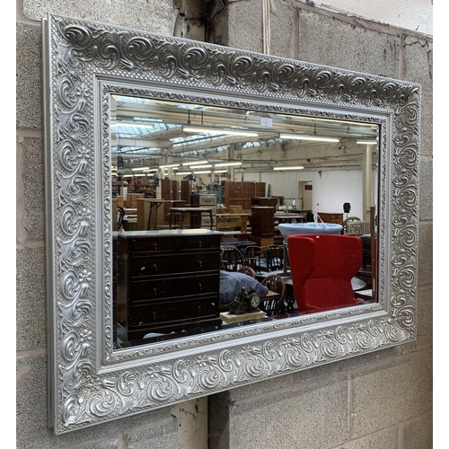 12 - A 19th century style silver painted framed bevelled edge wall mirror - approx. 87cm high x 115cm wid... 