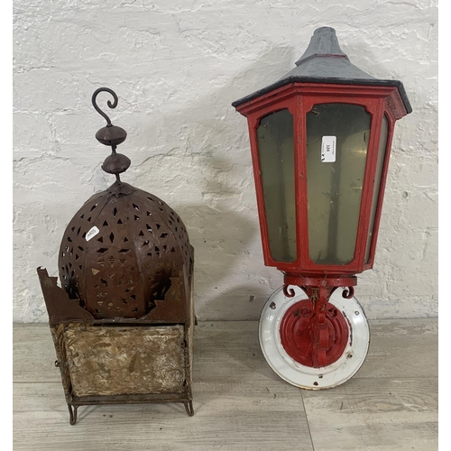 124 - Two lanterns, one Moroccan pierced metal and one red metal wall mountable