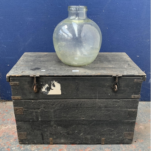 135 - Two items, one glass demijohn - approx. 36cm high and one early 20th century ebonised pine toolbox -... 