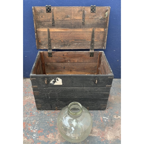 135 - Two items, one glass demijohn - approx. 36cm high and one early 20th century ebonised pine toolbox -... 