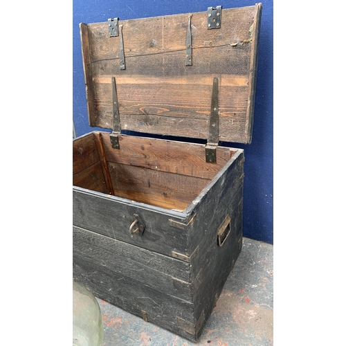 135 - Two items, one glass demijohn - approx. 36cm high and one early 20th century ebonised pine toolbox -... 