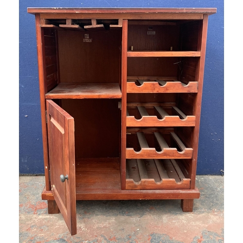 136 - A modern stained pine drinks cabinet with bottle rack - approx. 85cm high x 67cm wide x 36cm deep