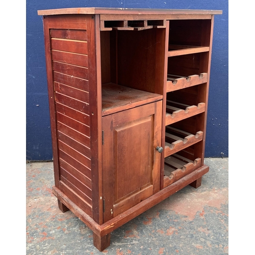 136 - A modern stained pine drinks cabinet with bottle rack - approx. 85cm high x 67cm wide x 36cm deep