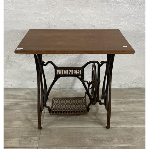 64 - A late 19th/early 20th century Jones cast iron treadle sewing machine base converted table - approx.... 